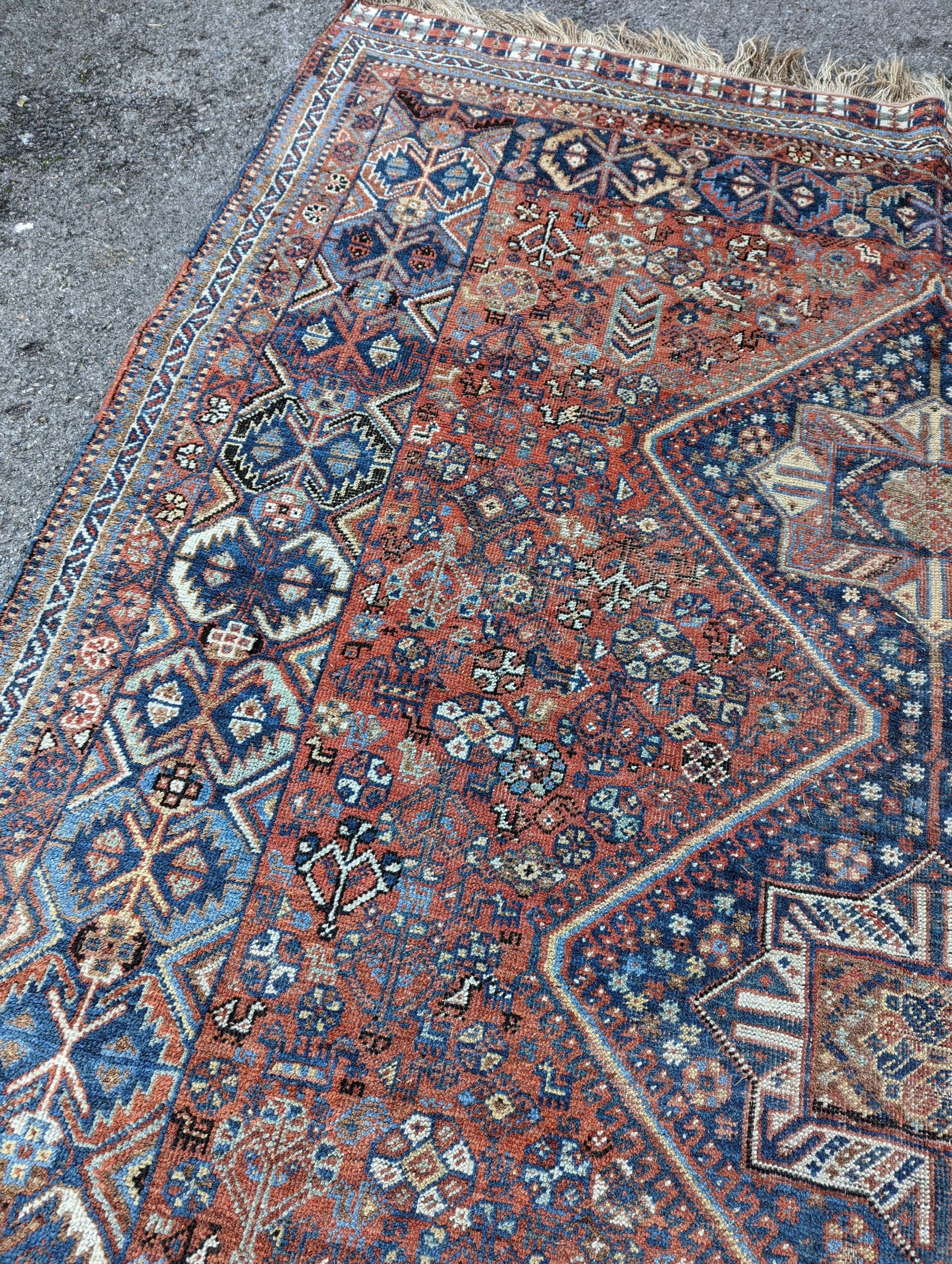 A Caucasian red ground carpet, 295 x 220cm